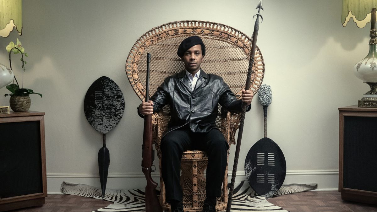 André Holland as Huey P. Newton in a wicker chair in The Big Cigar