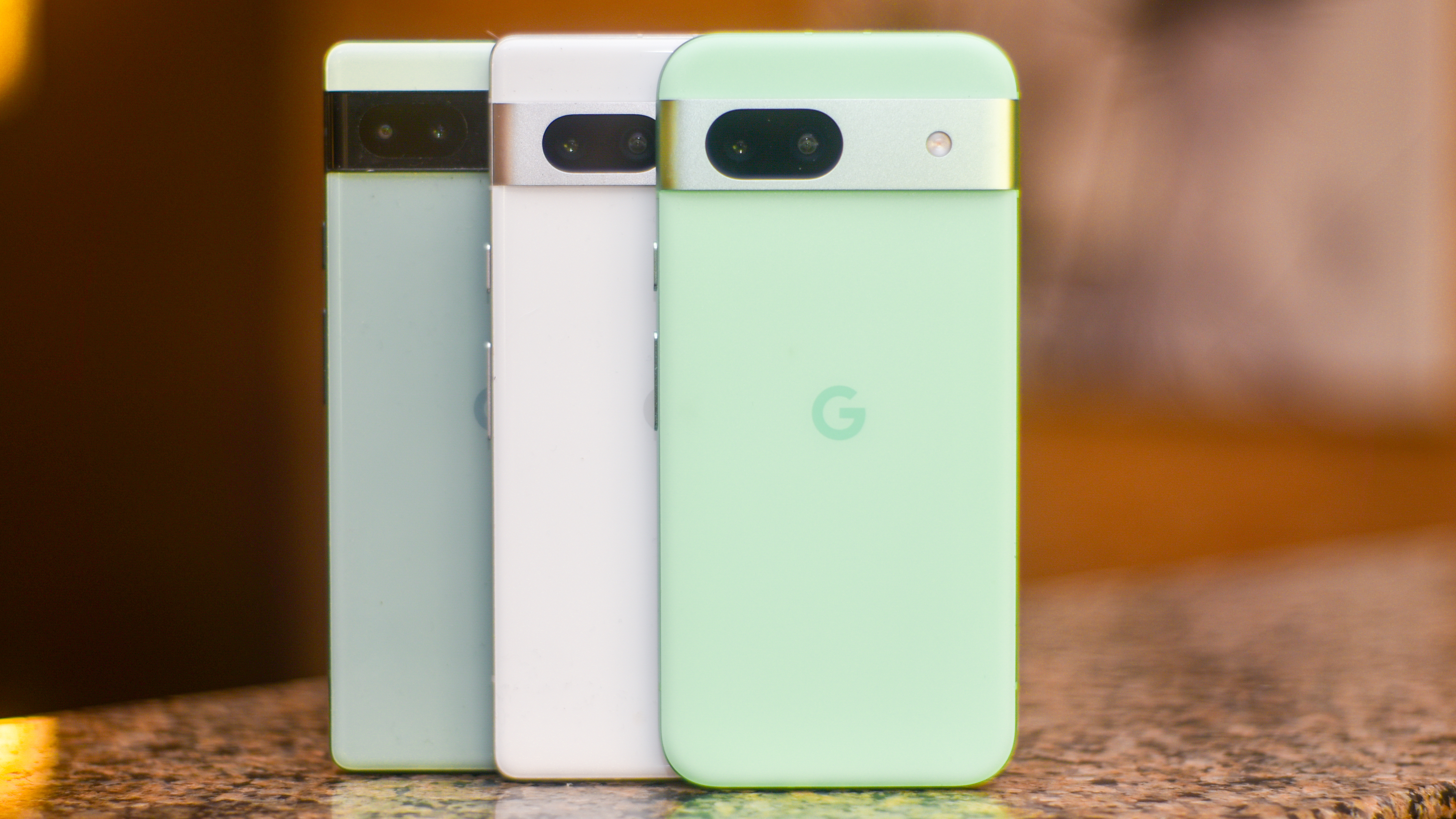 Google Pixel 8a in front of Pixel 7a and Pixel 6a