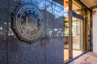 FBI headquarters on Pennsylvania avenue sign with traffic reflections at night