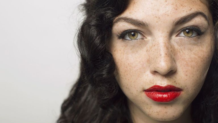 Woman with freckles and red lipstick