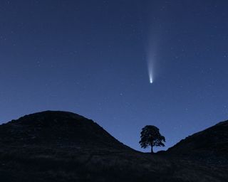 Britain's most romantic places to visit: shooting star in the night sky in northumberland