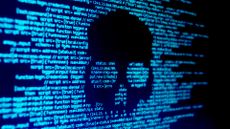Computer code on a screen with a skull representing a computer virus / malware attack.