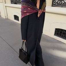 Creator @mimixn wearing a long black coat and colourful shawl