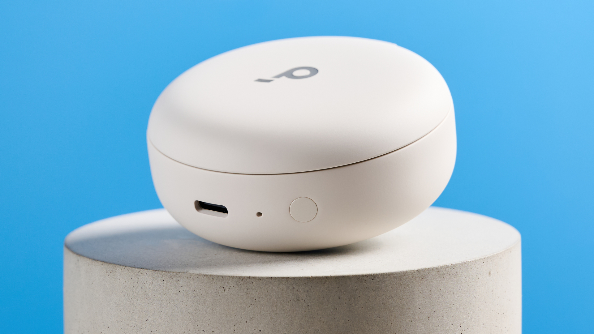 The Soundcore Sleep A30 earbuds case on a stone plinth against a blue background