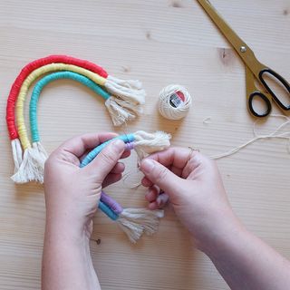 rainbow macrame bunting assembly with darning needle and scissors