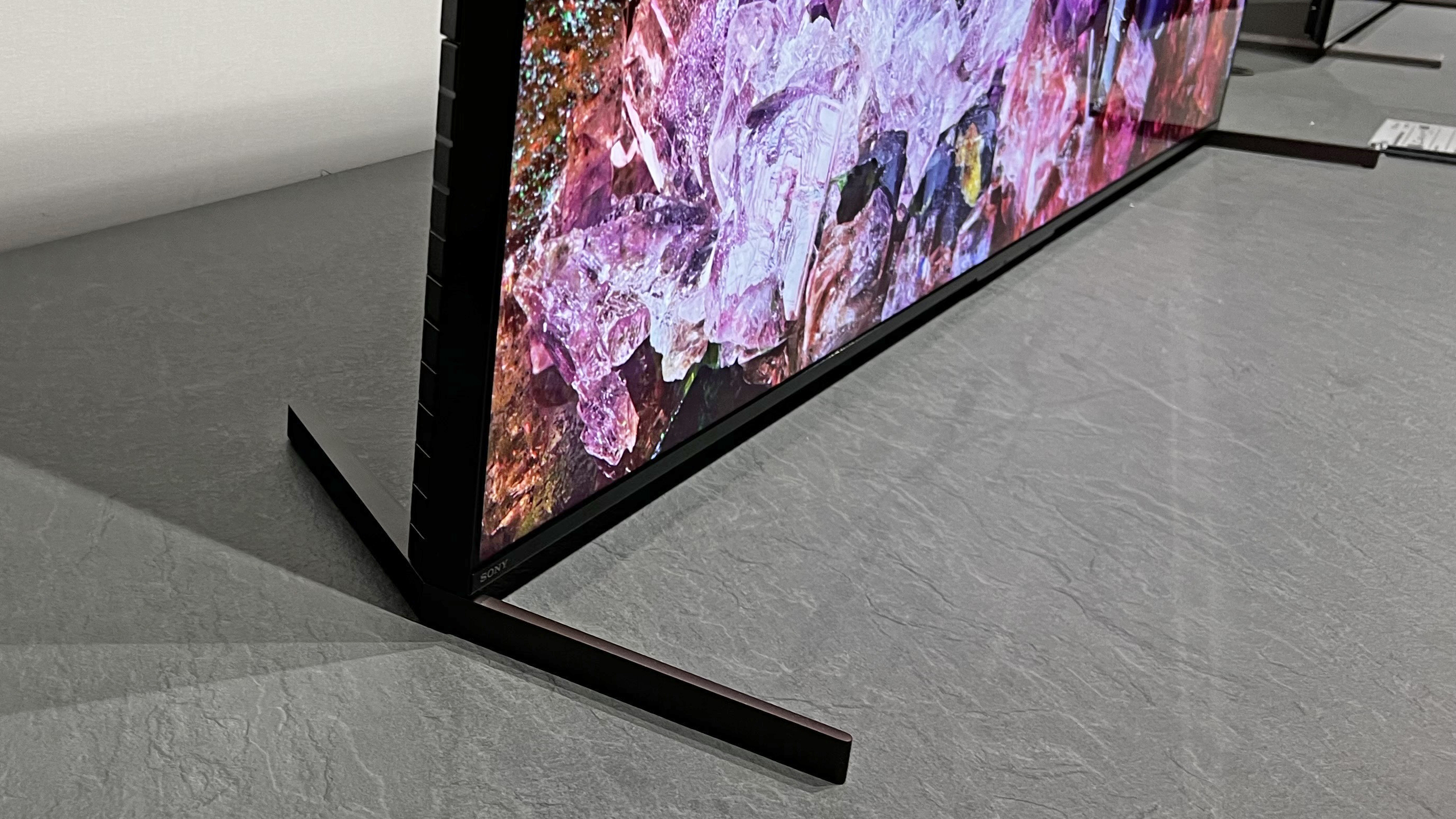 The Sony X95L on a TV stand, with an image showing a Japanese house