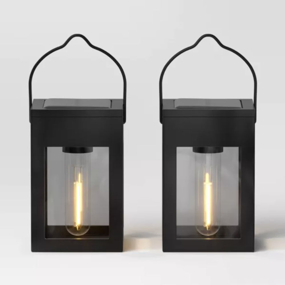 Two black outdoor solar lanterns 