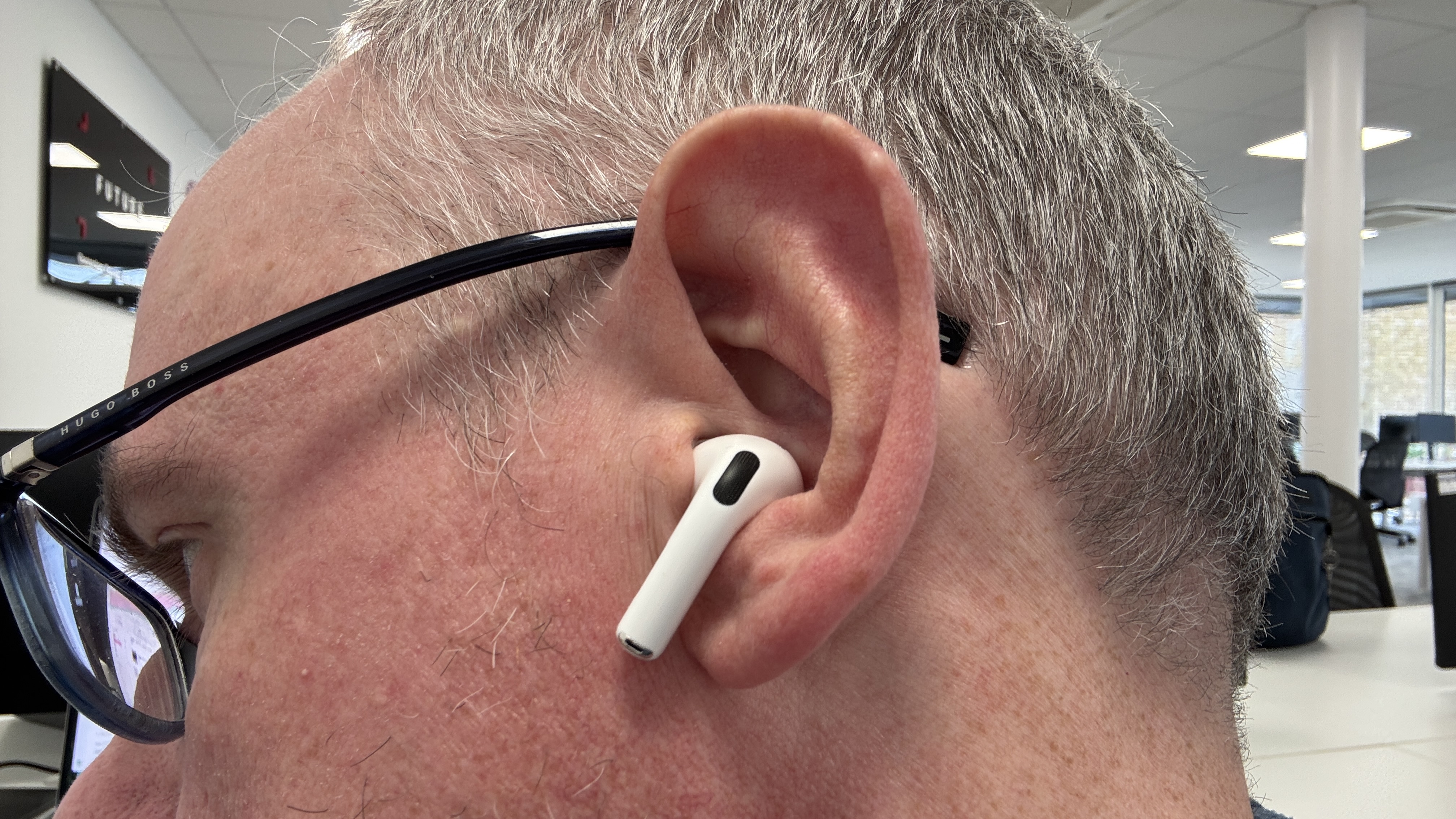 AirPods Pro 3 positioned in a man's left ear showing the fit