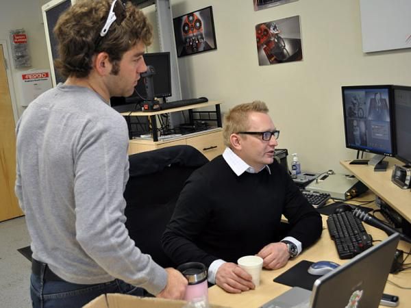 Aero consultant Chris Edin, right, helps Mike Friedman understand the meaning of the data flow recorded in the wind tunnel.