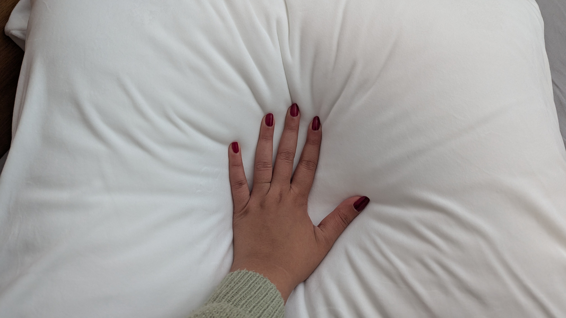 A shot of the hand pressed into the SquishPillow to show the feel and firmness