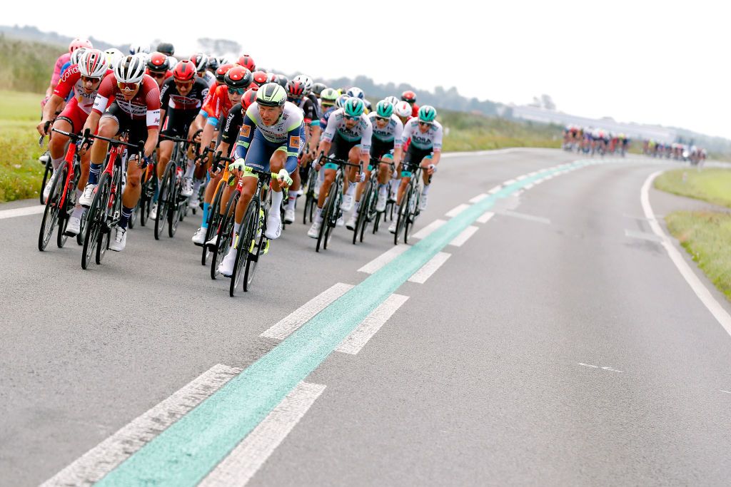 DOKKUM NETHERLANDS AUGUST 30 Emmanuel Morin of France and Team Cofidis Toms Skujins of Latvia and Team Trek Segafredo and Taco Van Der Hoorn of Netherlands and Team Intermarch Wanty Gobert Matriaux and the peloton compete during the 17th Benelux Tour 2021 Stage 1 a 1696km stage from Surhuisterveen to Dokkum BeneluxTour on August 30 2021 in Dokkum Netherlands Photo by Bas CzerwinskiGetty Images