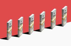 6 bundles of US $100 bills standing vertically on edge of white shelf, red background
