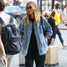 Michelle Monaghan wearing a denim jacket with a black tee and pants in NYC