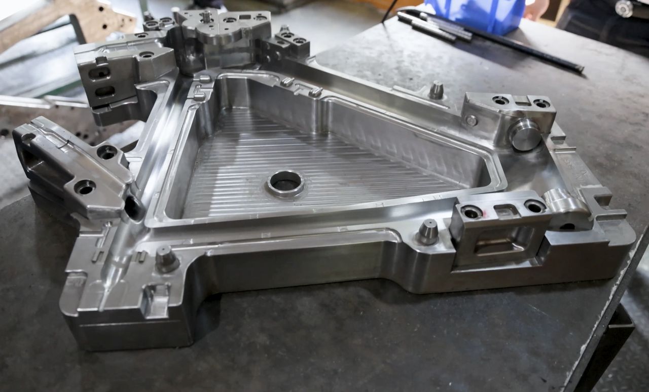 XDS Factory, raw carbon frame being assembled by workers