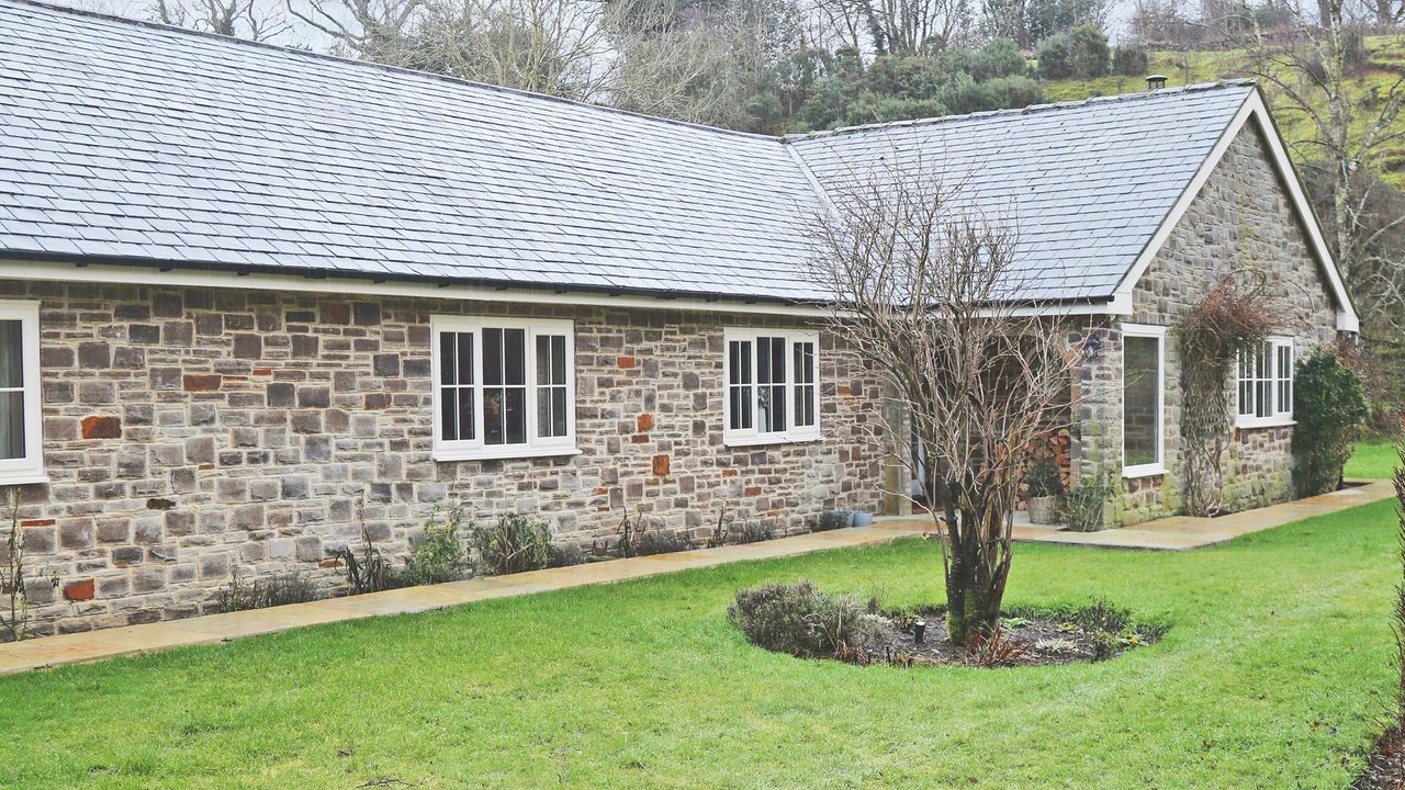 Frosted house next to front garden lawn in the winter