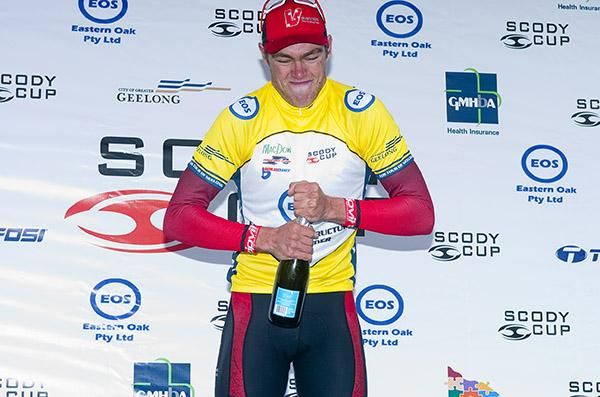 Scott Law (V Australia) comes to grips with the champers in his tour leader&rsquo;s yellow jersey.