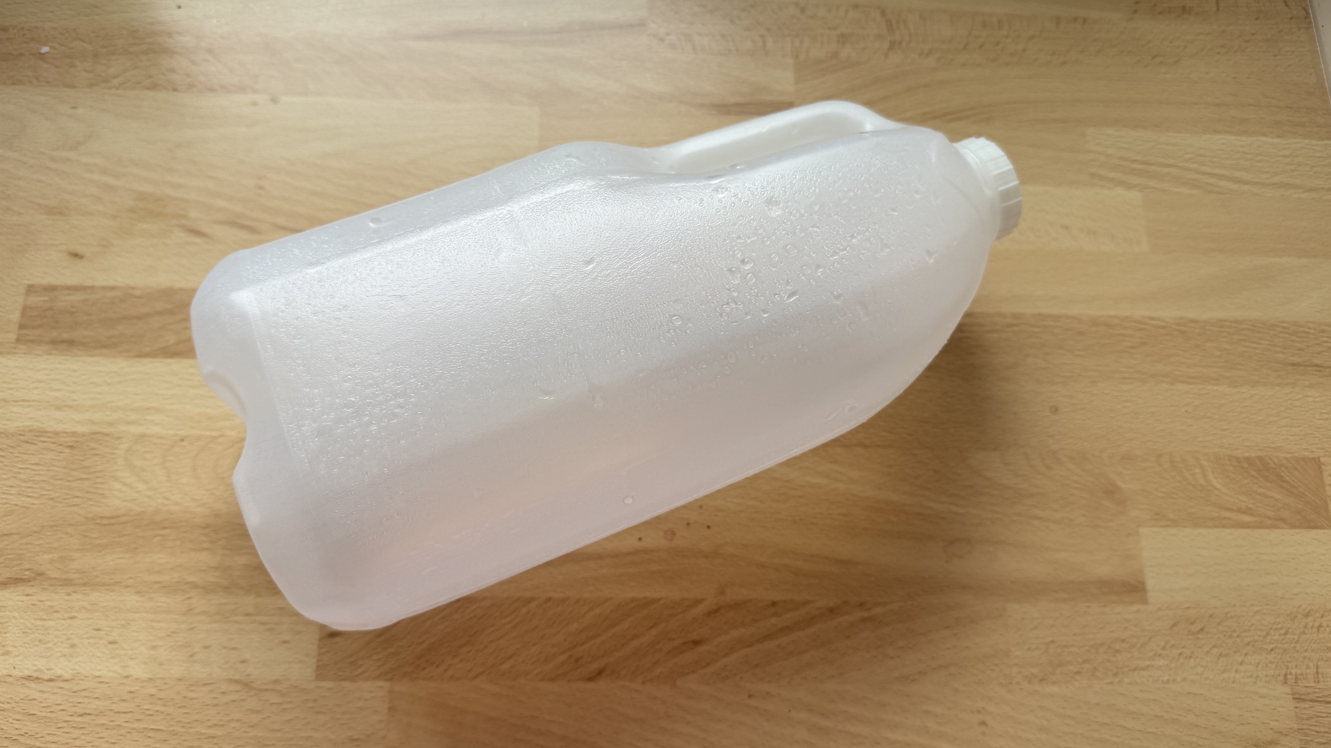 A milk jug being turned into a plant pot