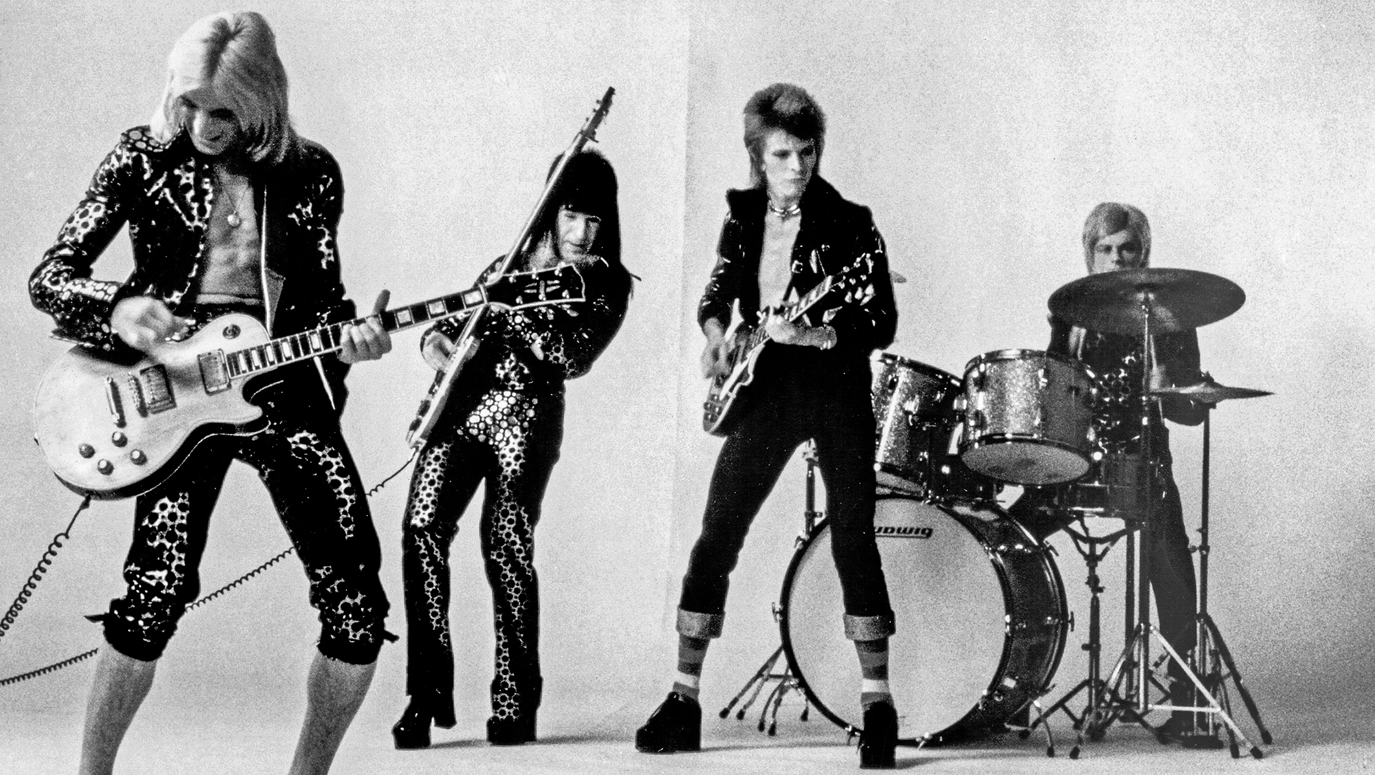 Guitarist Mick Ronson, bassist Trevor Bolder, David Bowie and drummer Mick Woodmansey of "Ziggy Stardust And The Spiders From Mars" pose for a portrait in November 1972 in London, England.