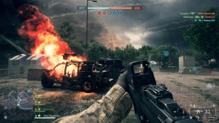 The player in Battlefield 6 in front of a flaming vehicle, rifle raised - from EDGE 415