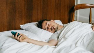 Man sleeping in bed holding Moonbird