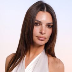 Emily Ratajkowski attended her first Dior show since 2017 in a white tunic and pleated black trousers