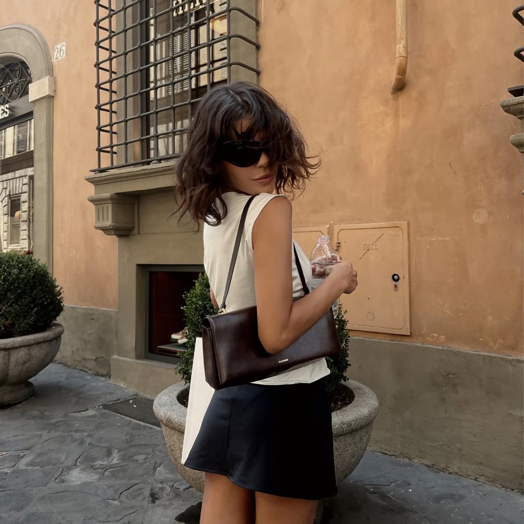 Jen Ceballos wearing black skirt and white top.