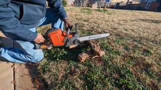 Best chainsaws | Image showing the Husqvarna Power Axe 350i Cordless Electric Chainsaw being tested on a small log