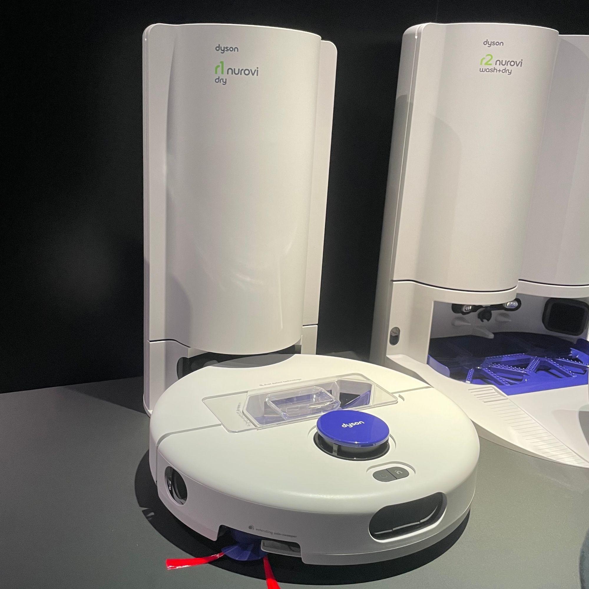 White Dyson R1 Nurovi robot vacuum sitting on its dock
