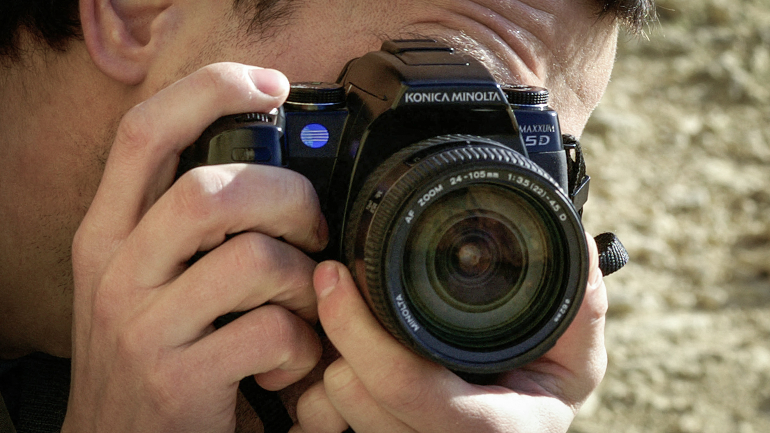 A9J03G man taking picture with a Konica Minolta 5D camera