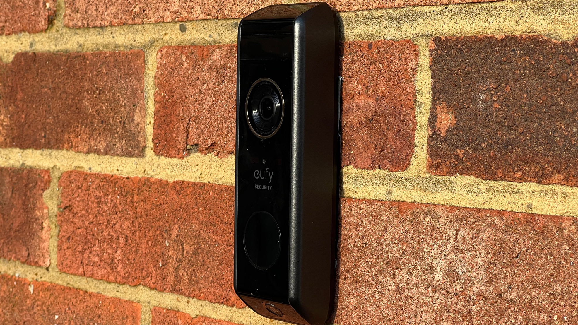 The side view of the Eufy Video Doorbell Dual on a brick wall