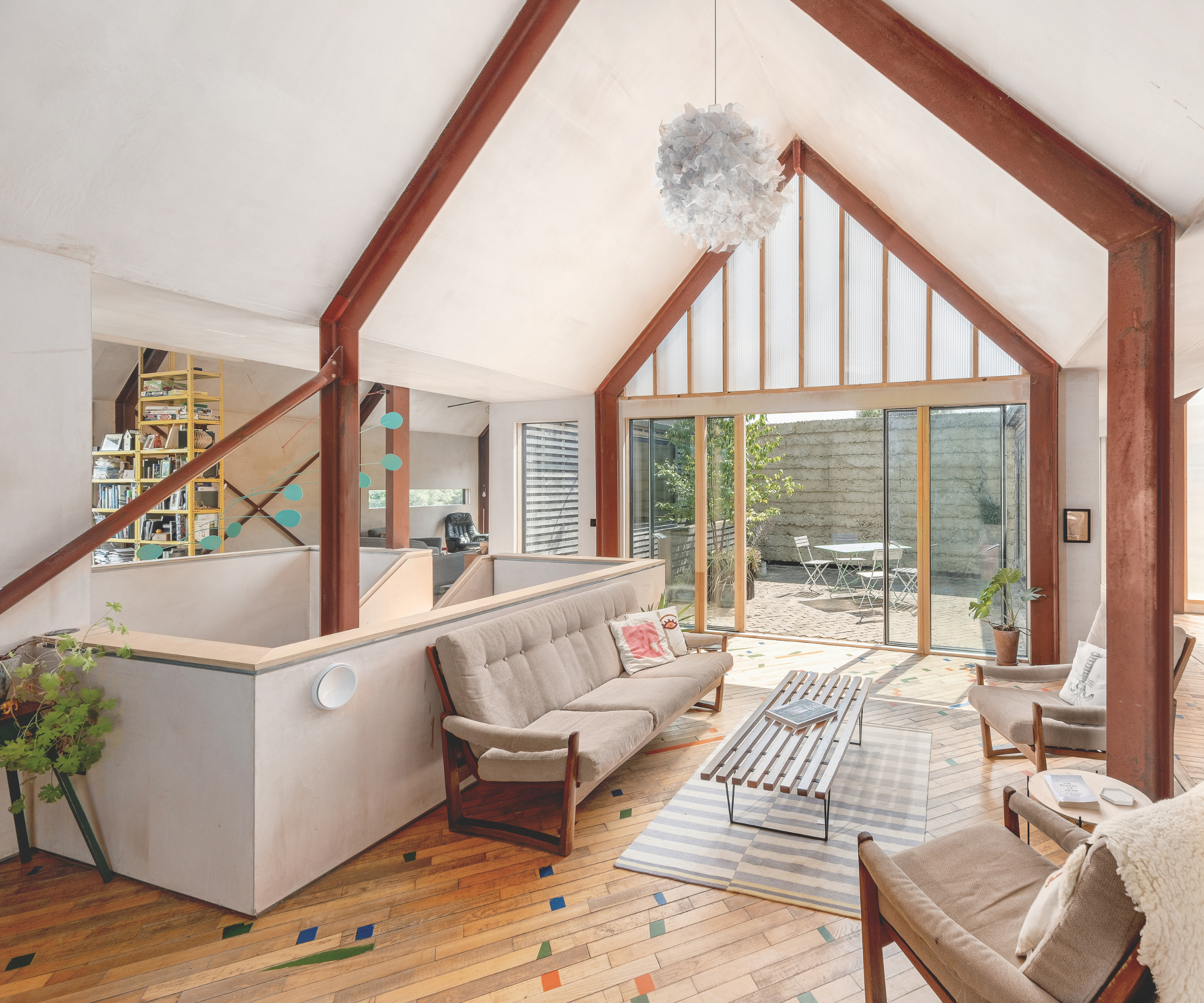 living room with colourful specs on wooden flooring planks