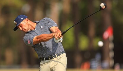 Bryson DeChambeau strikes a tee shot with a driver