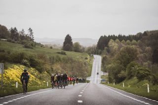 Riders cycling across the harsh Ardennes landscape at Liege-Bastogne-Liege Sportive