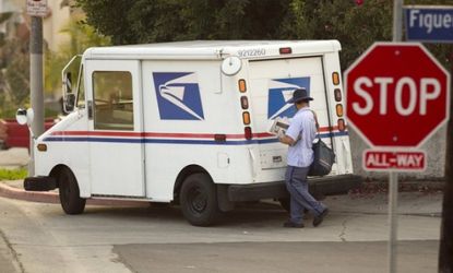 A mail carrier walks his route in Los Angeles on Feb. 6. 