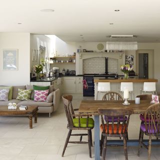 kitchen area with grey sofa and dining table