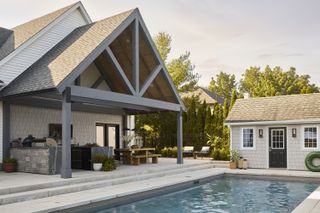 The after picture of a backyard in Ontario, Canada, with a newly built pool, dining area and lounge area