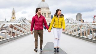 young couple walking hand in hand on bridge in front of St Pauls Cathedral