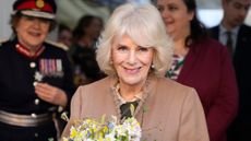 Queen Camilla wears mismatched earrings as she leaves after a visit to a women's refuge on January 22, 2024 in Swindon, England