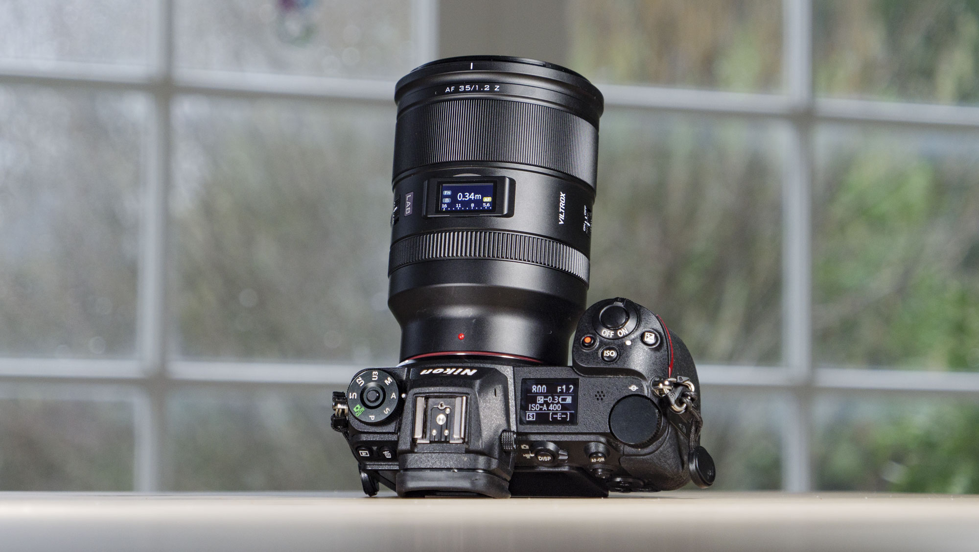 Viltrox AF 35mm F1.2 LAB Z lens for Nikon, attached to a Nikon Z6 II, on a wooden table