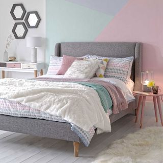 bedroom with block pattern wall and table lamp