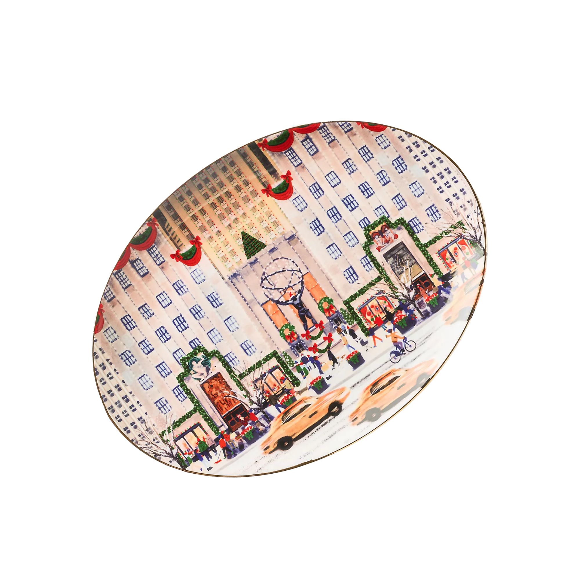 An oval shaped Christmas plate with an illustration of a hotel with taxis in front of it on it