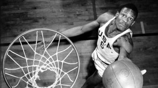 top-down black and white photo of Bill Russell on the University of San Francisco basketball team shooting a lay-up for Bill Russell: Legends