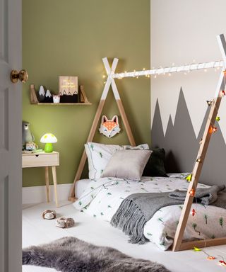 boys' bedroom with green wall, bed and wall art