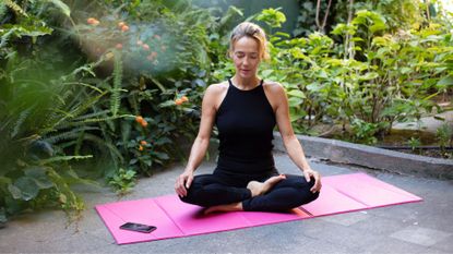 A woman stretching as part of a yoga practice 