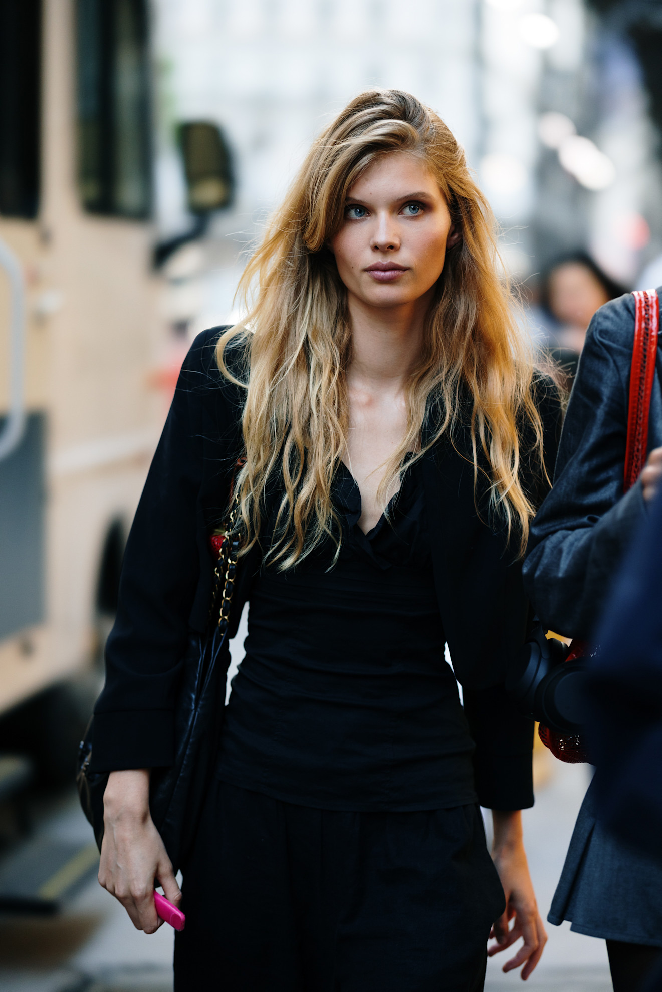 a blonde woman with long hair wearing a black jacket during new york fashion week