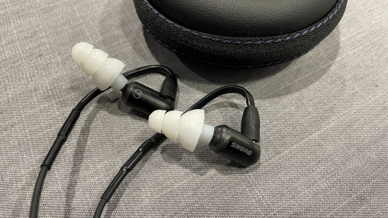 Shure Aonic 3 wired in-ear headphones placed next to their case