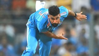 Action shot of Indian cricketer Mohammed Siraj bowling at full tilt prior to the start of the India vs South Africa live stream at the 2023 ICC Men's Cricket World Cup.