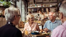Close up of a group of seniors enjoying food in a restaurant