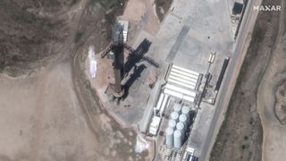 SpaceX's Starship and Super Heavy rocket are seen from orbit by a Maxar Earth-observation satellite as they stoop atop their pad at SpaceX's Starbase facility in Boca Chica, Texas on April 17, 2023. 