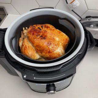 Ninja Foodi 9-in-1 Multi-Cooker with whole cooked chicken inside